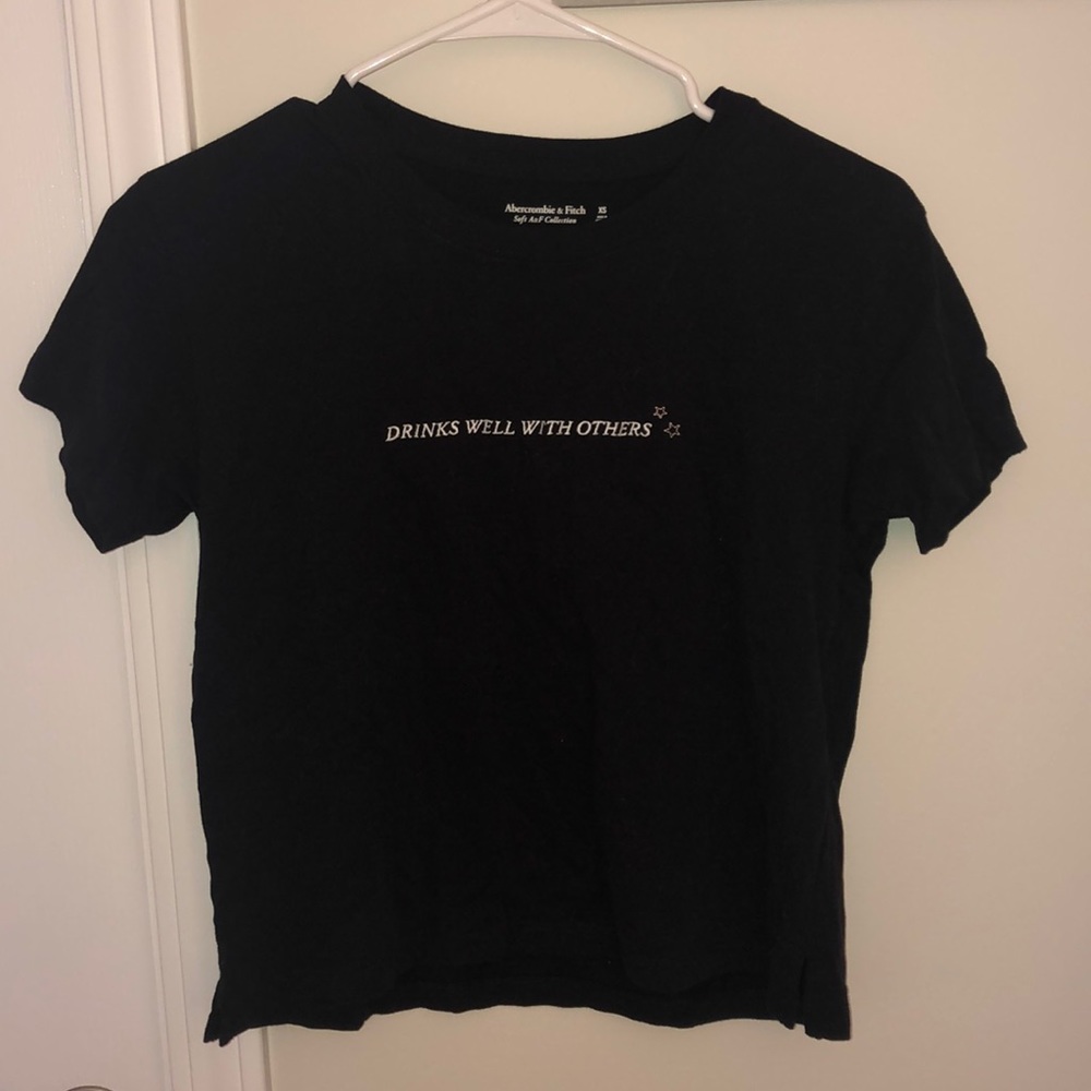 Black “drinks well with others” tee